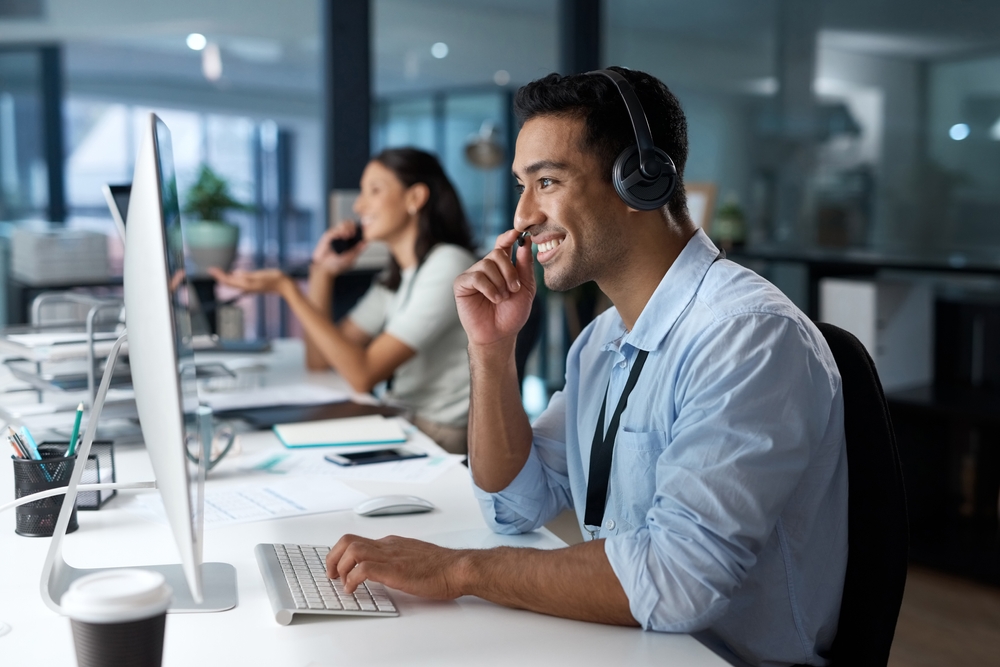 Office worker using a headset to stay connected through cloud-based unified communications solutions
