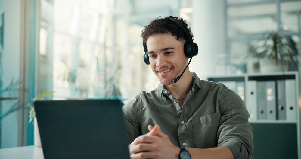 Remote employee wearing a headset taking a business call from home through a hosted VoIP app
